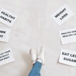 person legs with motivational words on papers on white background